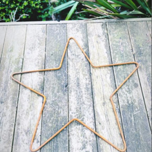 Load image into Gallery viewer, Rustic garden star on grey decking in the garden with some grass over lapping