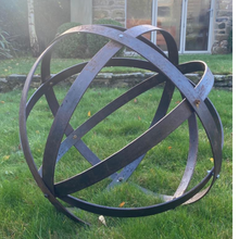 Load image into Gallery viewer, The 80cm rustic garden ball sculpture with the summerhouse in the background.