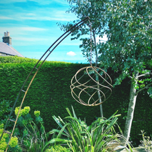 Load image into Gallery viewer, Rustic garden sculpture in garden with blue skies and tree in the background.