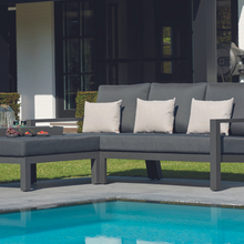 Load image into Gallery viewer, The Timber Chaise outdoors by the pool.
