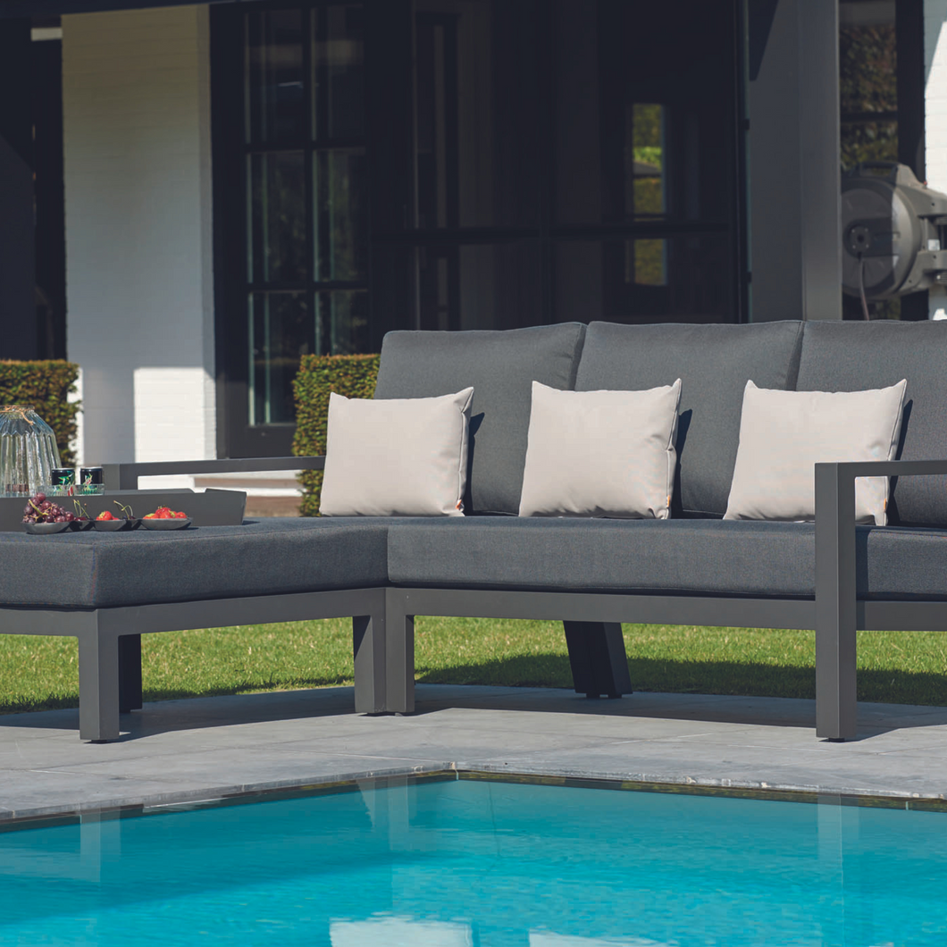 The Timber Chaise outdoors by the pool.