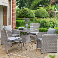 Load image into Gallery viewer, The Morston 2-4 Seat Dining Set in Grey outside in the garden. 
