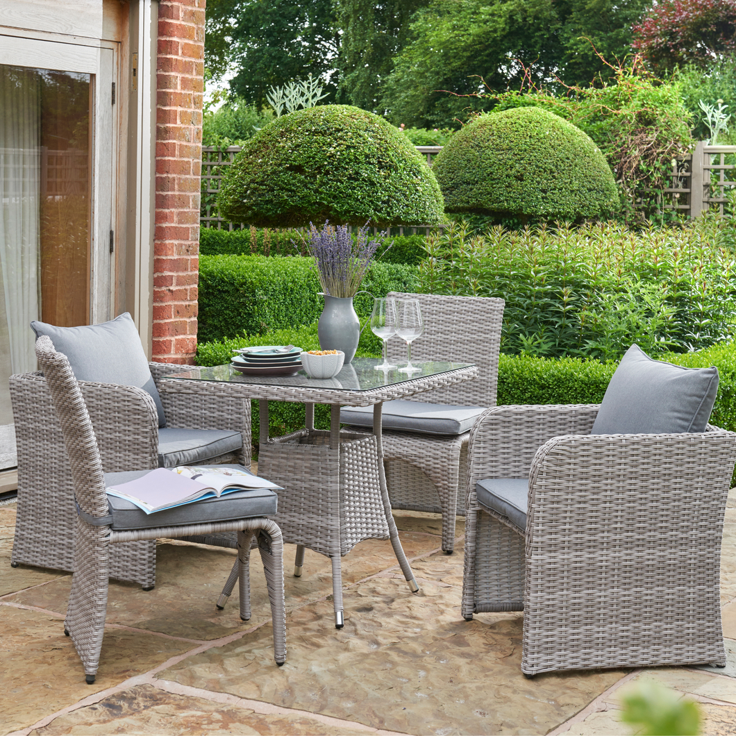 The Morston 2-4 Seat Dining Set in Grey outside in the garden. 