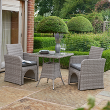 Load image into Gallery viewer, The Morston 2/4 Seat Dining Set in Grey with two seats in the garden.
