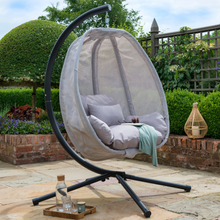 Load image into Gallery viewer, The folding textilene swing in grey outside in the garden. 
