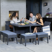 Load image into Gallery viewer, Three people sat around the Santiago 9 piece garden dining set. The three people are saying cheers with their glass of wine. 
