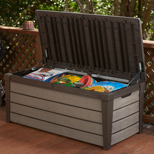 The Keter brushwood storage box opened with garden accessories inside. 