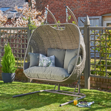 Load image into Gallery viewer, The Goldcoast double swing grey chair in the garden. 
