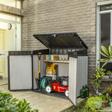 Load image into Gallery viewer, The Keter Elite Storage Box Duotech outdoors in the garden.
