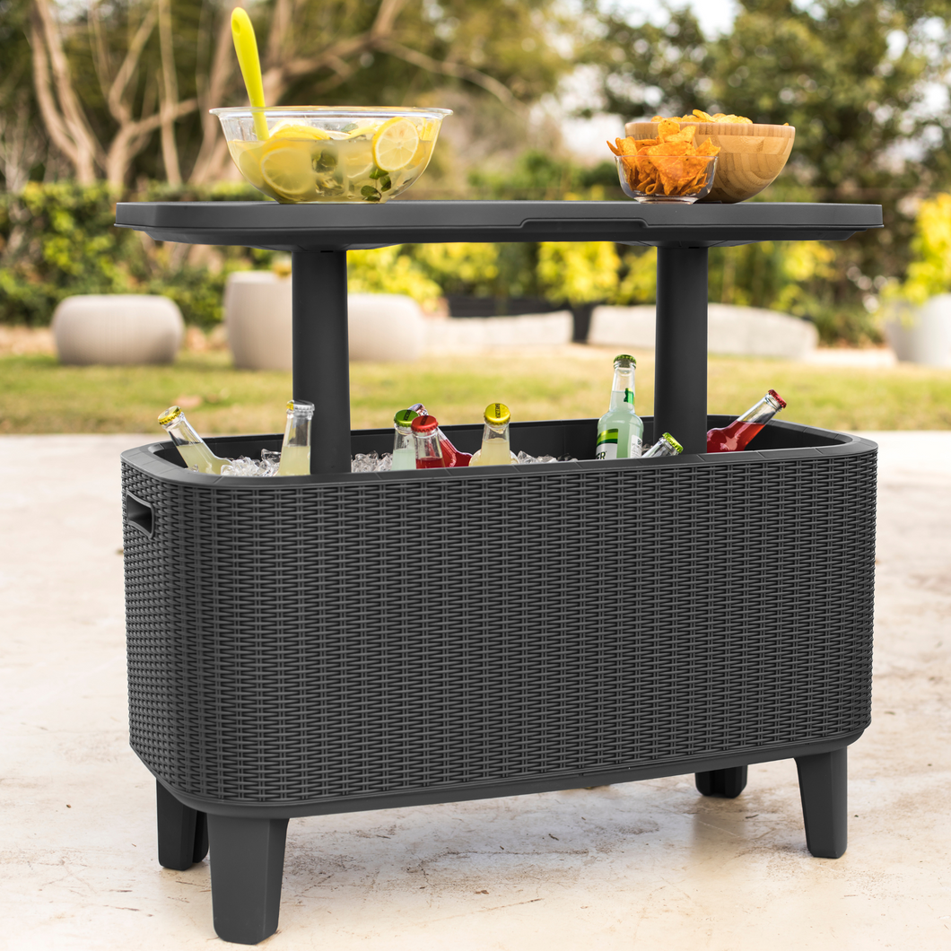 The Keter bevy bar with the table raised with two dishes with snacks on top. Inside the bar shows multiple drinks and ice inside. 