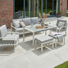 Load image into Gallery viewer, The Titchwell lounge set in white on a garden patio. 
