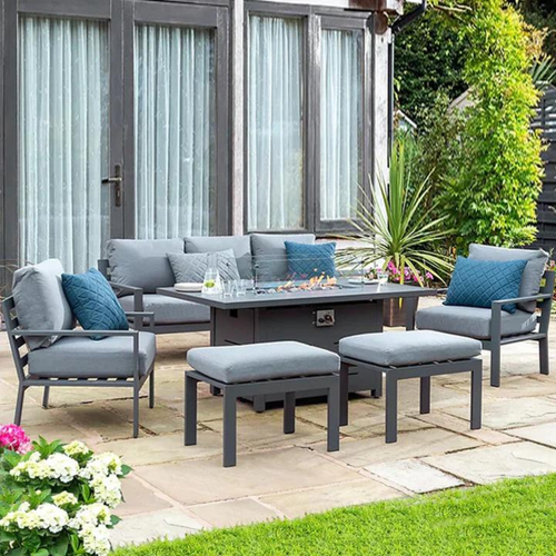 The Titchwell lounge set with firepit table on a garden patio. 