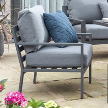 Load image into Gallery viewer, The Titchwell lounge grey chair with blue cushion. 
