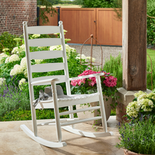 Load image into Gallery viewer, The Oakwell white rocking chair outside in the garden. 
