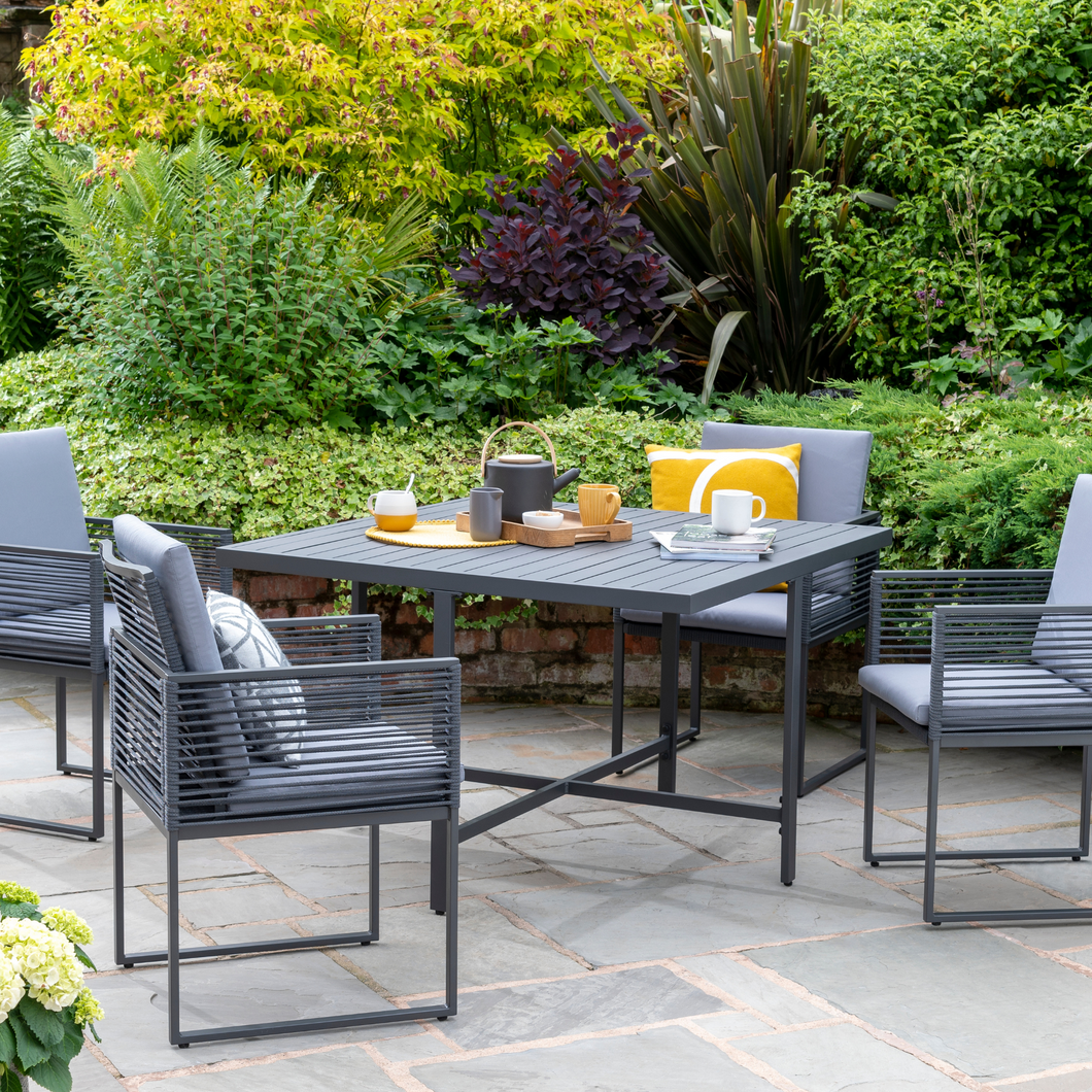 The Sheringham Alu Rope Cube Dining Set outside in the garden.