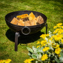 Load image into Gallery viewer, 50cm fire pit outside in the garden with wood inside ready to be lit. 
