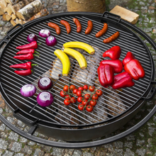 Load image into Gallery viewer, Cook King natural steel grill with various food on top ready to grill. 
