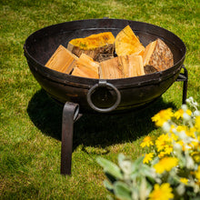 Load image into Gallery viewer, 80cm fire pit in garden showing the drop handles and metal stand. 
