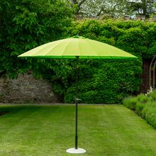 Load image into Gallery viewer, The lime geisha parasol in the garden. 
