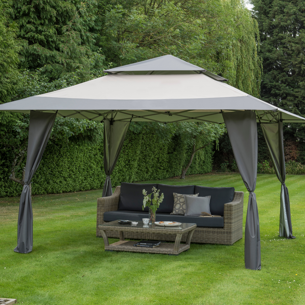 The Got It Covered 4x4m Pop Up Gazebo Grey outside in the garden. 