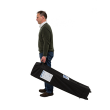 Load image into Gallery viewer, A man holding the handle on the carrier case for the gazebo. 
