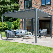 Load image into Gallery viewer, The Pandora Leaf Pergola in the garden. The pergola is over some garden furniture .
