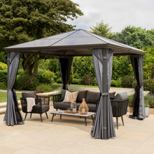 Load image into Gallery viewer, The Runcton Polycarbonate 3.6m Gazebo with open curtains and nets in the garden. 
