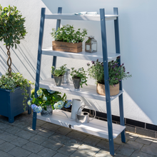 Load image into Gallery viewer, The Florenity Galaxy Plant Shelf with pots and flowers displayed outside in the garden.
