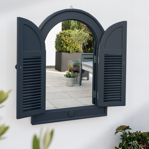 The Florenity Galaxy Outdoor Arch Mirror on a white wall with opened front doors. 