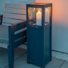 Load image into Gallery viewer, The Florenity Galaxy candle lamp outdoors next to a chair. 
