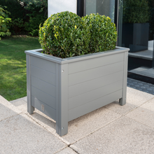 Load image into Gallery viewer, The Florenity Grigio Rectangular Planter outside on the garden patio
