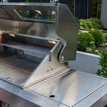 Load image into Gallery viewer, The Norfolk Grills absolute 6 burner free standing grill with Side burner and cabinet with lid open and lights on. 
