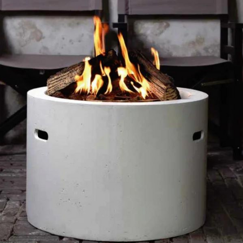 The Cocoon Grey round fire bowl with the fire lit. 
