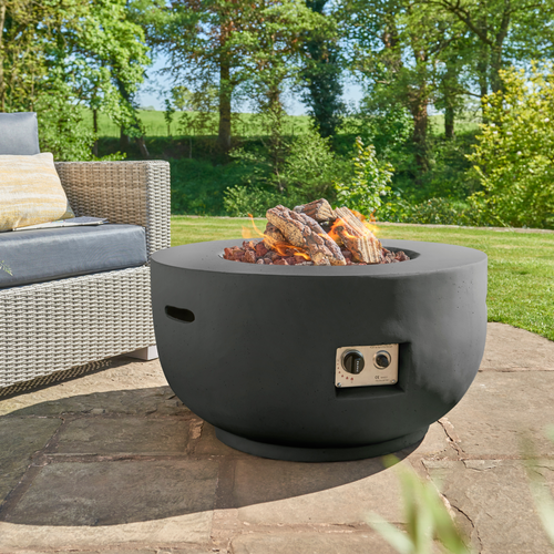The Cocoon Fire Bowl Black in the garden. 
