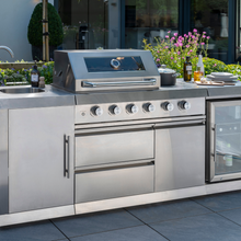 Load image into Gallery viewer, The Norfolk Grills Absolute Pro 4 Outdoor Kitchen Inc Fridge &amp; Sink outside with plates and condiments on the outside kitchen. 

