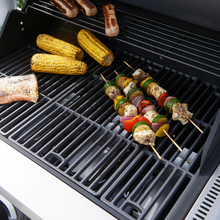 Load image into Gallery viewer, The Norfolk Grills Atlas 300 bbq grill showing kebabs, sweetcorn, sausages and fish cooking. 
