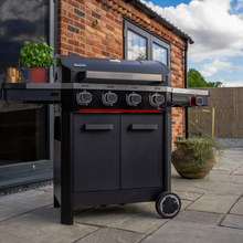 Load image into Gallery viewer, The Norfolk Grills Atlas 400 Gas 4 Burner With Side Burner outside in the garden. 
