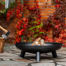 Load image into Gallery viewer, Cook King Bali fire pit outside with red leaves in the background on a brick wall.
