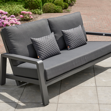Load image into Gallery viewer, The Boston lounge sofa outside in the garden patio with the pillows.  
