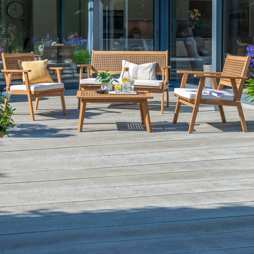 The Brent lounge set natural with cushion outside on the garden decking. 