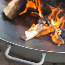 Load image into Gallery viewer, Cook King Bali fire pit with fire inside showing detail of the handle. 
