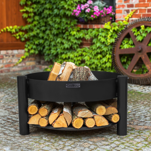 The Cook King Montana 80cm Fire Pit Low outside in the garden. 