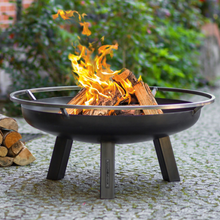 Load image into Gallery viewer, The Porto fire pit with fire lit in the garden. 
