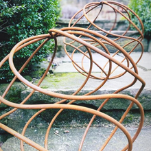 Load image into Gallery viewer, The 40cm rustic garden balls shown on the steps of the garden. 
