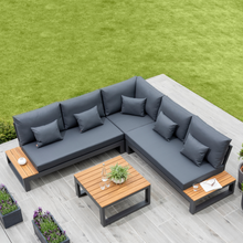 Load image into Gallery viewer, The Soho corner lounge set with side tables outside in the garden.
