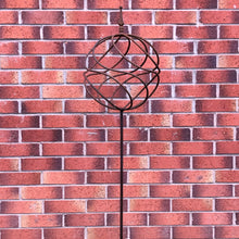 Load image into Gallery viewer, Decorative garden stake with a sphere on top with a brick background.
