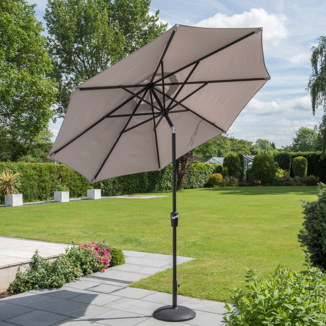 The Elizabeth parasol in taupe outside in the garden.