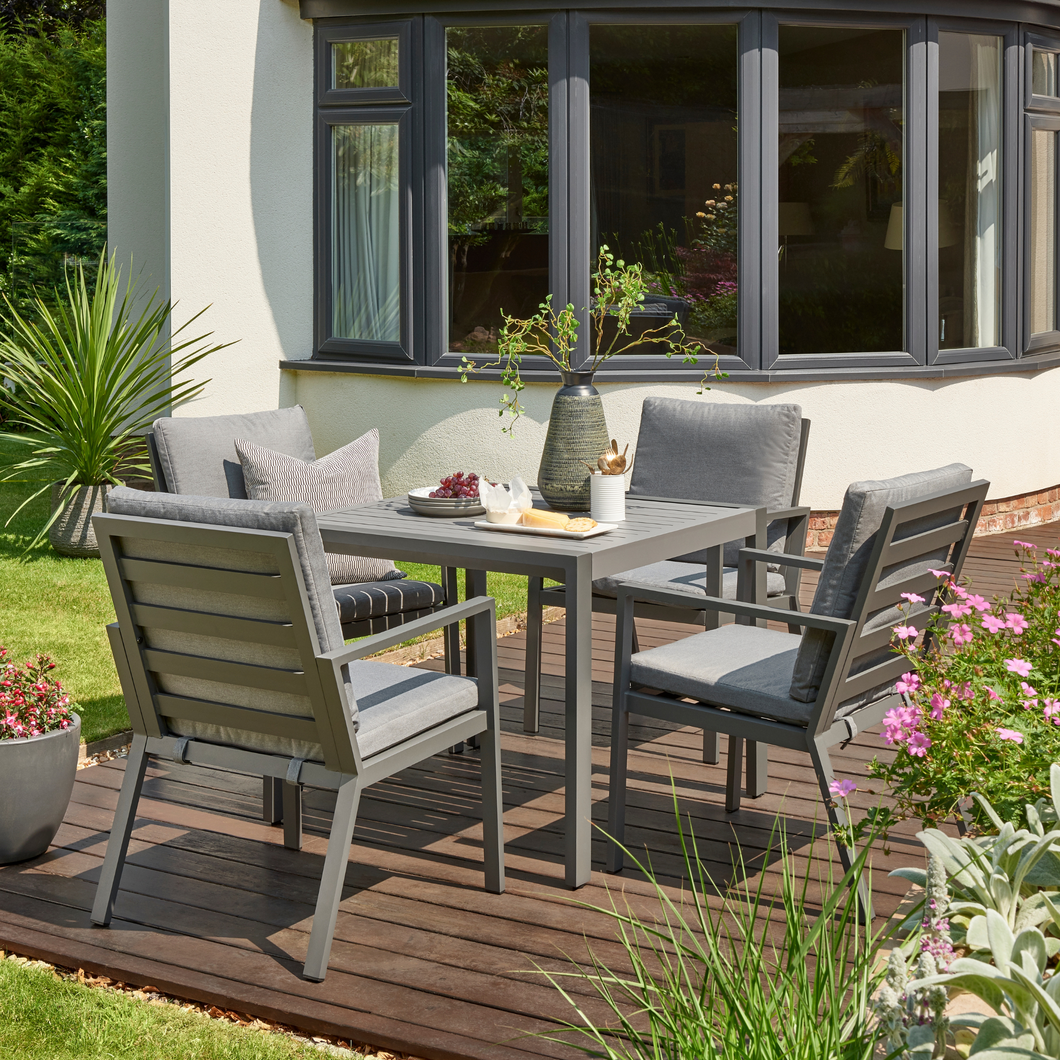 The Titchwell four seat grey dining set in the garden. 