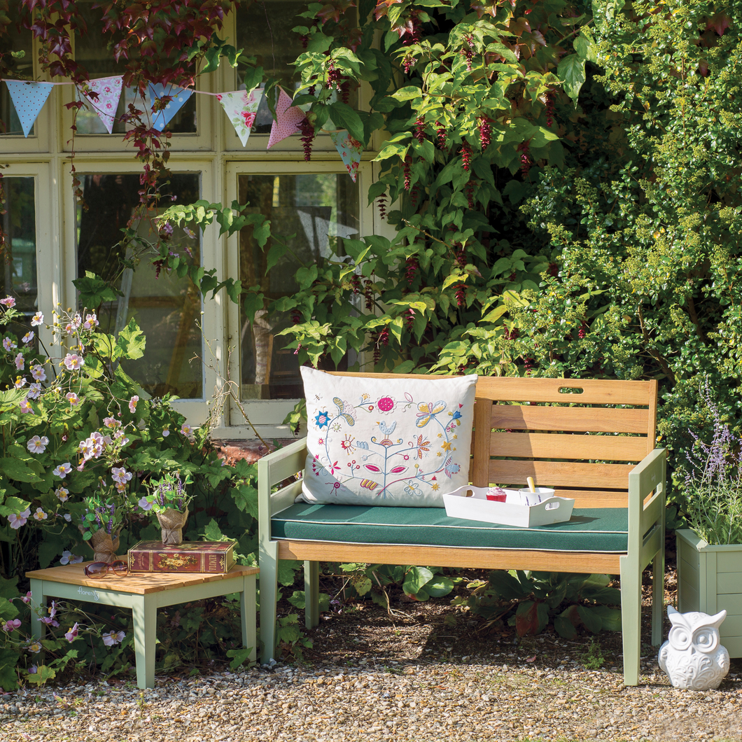 The Florenity Verdi Two Seat Bench outside in the garden. 