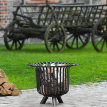 Load image into Gallery viewer, The Cook King Verona 60cm Fire Basket on some garden stone with grass in the background.
